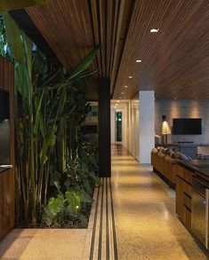 the interior of a modern house with wood and stone accents, including an outdoor kitchen