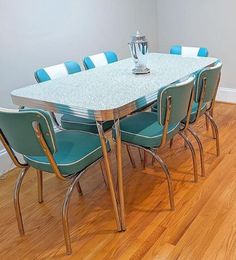 a dining room table with blue chairs around it