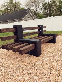 a wooden bench sitting on top of a gravel field