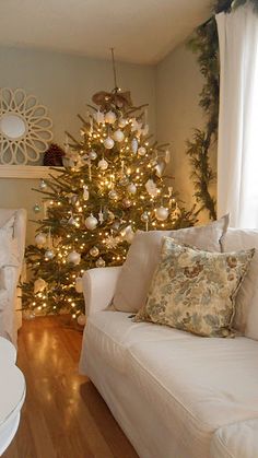 a living room with a christmas tree in the corner