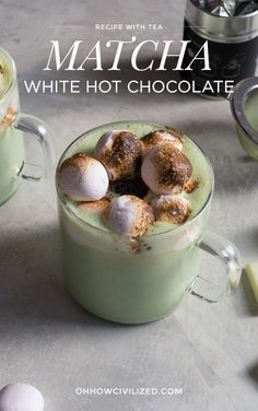 two mugs filled with hot chocolate and marshmallows