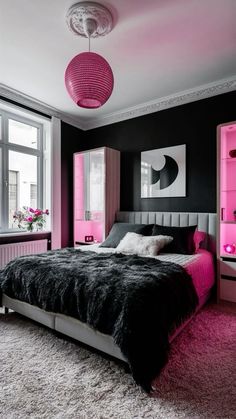 a bedroom with black and pink walls, carpeted flooring and a large bed