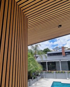 an outdoor swimming pool with wooden slatted walls