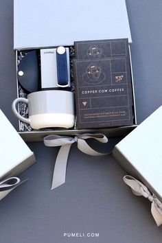 an open box with coffee cups and spoons in it