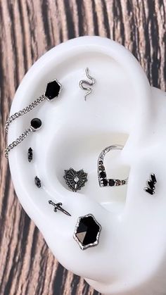 several pieces of jewelry sitting on top of a white bowl