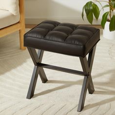 a foot stool sitting on top of a white rug