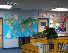 an empty library with bookshelves and a world map on the wall