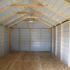 the inside of a storage building with wood flooring