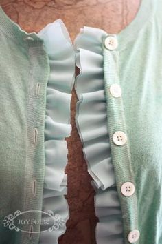 the back of a woman's green shirt with ruffles on it and buttons