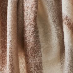 the fabric is made up of different shades of brown and white yarn, which are woven together