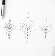 three sun and moon tattoos on a white paper next to a pen with an ink marker