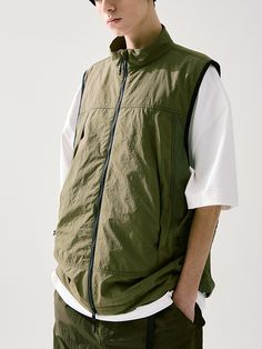 This is a casual and comfortable vest that is made out of high quality nylon 100% fabric. With design detail of 2-way zipper closure, inner zipper pocket, and console zipper pockets on the side, it gives a trendy and casual mood.- 2-way zipper closure- Adjustable string and stopper on the hem- Inner zipper pocket- Relaxed armhole for comfortable wear Casual Streetwear Vest With Functional Pockets, Spring Outdoor Nylon Vest, Nylon Vest For Streetwear, Techwear Nylon Vest For Streetwear, Sleeveless Nylon Outerwear For Streetwear, Casual Sleeveless Vest With Functional Pockets, Casual Nylon Vest With Side Pockets, Spring Nylon Vest With Pockets, Sleeveless Green Nylon Outerwear