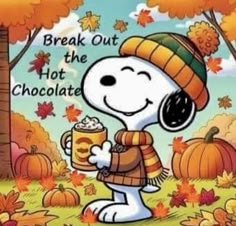 a snoopy holding a cup of hot chocolate in front of fall leaves and pumpkins