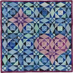 a blue and purple quilt with hearts on it