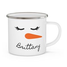 a white enamel mug with an orange nose and black lettering that says,'britain '