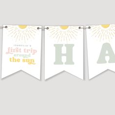 three banners with the letter h on them hanging from a clothes line, one has sunbursts