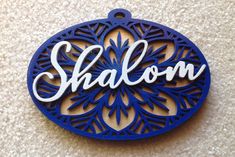 a blue and white ornament with the word shalow on it's side