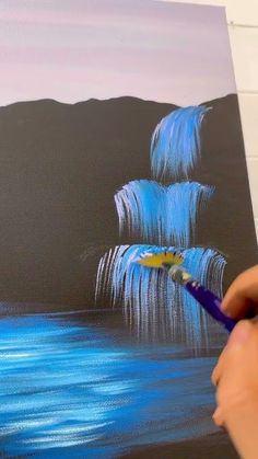 someone is painting an ocean scene with blue waves