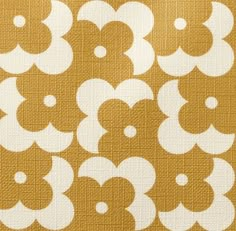 an orange and white pattern on fabric with small circles in the shape of letters,