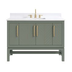 a bathroom vanity with a white counter top and gold handles