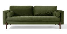 a green couch sitting on top of a white floor