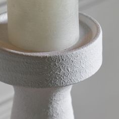 a close up of a white cake on a stand