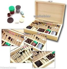 an assortment of sewing supplies in a wooden box with matching buttons and thread spools