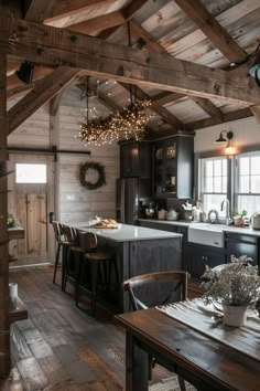 an open kitchen and dining room with wood flooring in a rustic cabin style home