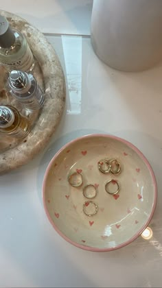 a plate with three rings on it next to a bottle