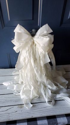 a white bow on top of a wooden table