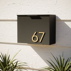 a black mailbox with the number 76 on it