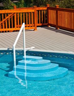 an above ground swimming pool with steps leading up to it