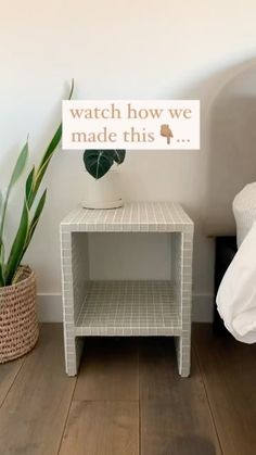 a white table with a sign that says watch how we made this next to it