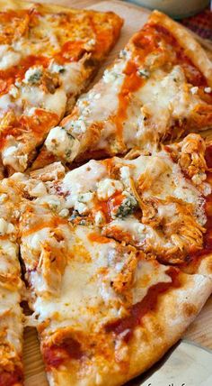 a pizza sitting on top of a wooden cutting board