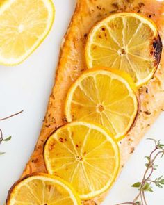 fish with lemon slices and herbs on the side