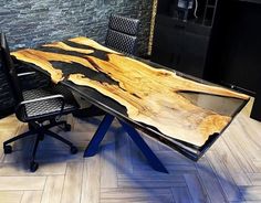 a desk made out of wood and metal with two chairs around it on the floor