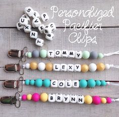 four personalized pacifier clips with name beads