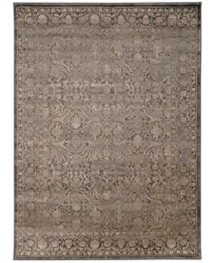 an antique rug with grey and beige colors