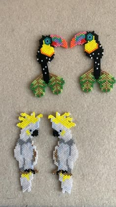 three pieces of bead art with toucan birds on them, one is white and the other is yellow