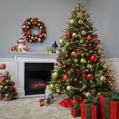 a decorated christmas tree sitting in front of a fire place with presents on the floor