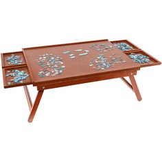 a wooden tray with blue and white mosaics on it, sitting on top of a table