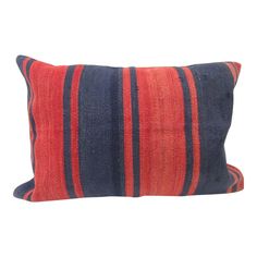 an orange and blue striped pillow on a white background