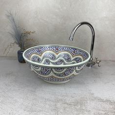 a bowl shaped sink sitting on top of a counter