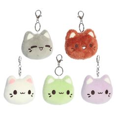 four key chains with different colored cats on them