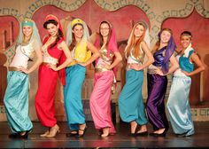 a group of women standing next to each other on a stage