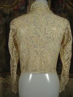 "Exquisite turn-of-the-century, entirely handmade, bobbin lace blouse, of pale ecru silk thread in an amazingly intricate design. This is a rare find and a wonderful example of just how beautiful handmade lace can be. I've had this in my personal collection for over 20 years, and parting with it will be difficult because it's unlikely that there is another like it. However, I do enjoy sharing fine things with my customers. It's a small size, about a 4, and measures approx. 14\" across the should Elegant Cream Top With Crochet Lace, Elegant Cream Crochet Lace Top, Cream Lace Blouse With Crochet Detail, Victorian Lace For Wedding, Elegant Beige Lace Top With Crochet Details, Formal Delicate Lace Top, Elegant Beige Crochet Lace Top, Victorian Cream Lace For Vintage Events, Vintage Long Sleeve Lace Top