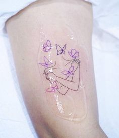 a woman's arm with purple butterflies on it and a tattoo design in the shape of a girl