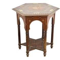 an old wooden table with a tile top and two columns on the sides, all turned down