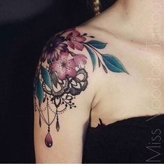 a woman's shoulder with flowers and jewels on her left arm, tattoo style