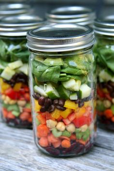 four mason jars filled with different types of salads and veggies, all labeled high - protein mason jar salads